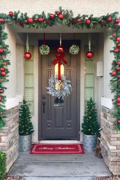 the front door is decorated with christmas decorations