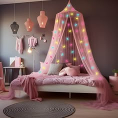 a bedroom with pink bedding and lights on the walls