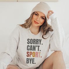 Whether you're a sport-loving Mom or Dad, or a passionate participant, our "SORRY. CAN'T. SPORT. BYE." sweatshirt is the ideal addition to your wardrobe. Made with a cozy cotton polyester blend, it lets you express your devotion to sports while staying snug and stylish. A unisex style in a medium-heavy blend that is 50% cotton, 50% polyester. This sweatshirt is a classic crewneck style. The collar is a ribbed knit, which retains its shape even after washing. These sweaters are free of itchy side Athletic Heather Team Spirit Sweatshirt For Sports, Athletic Heather Sportswear Sweatshirt For Sports Season, Winter Sports T-shirt, Athletic Heather Graphic Print Sweatshirt For Sports, Sporty Sweatshirt For Sports Season, Sporty Winter T-shirt For Sports Events, Casual Sportswear Tops, Athletic Heather Sporty Sweatshirt For Sports, Winter Sports T-shirt With Letter Print