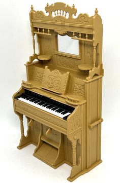 an old fashioned wooden toy piano with mirror on top and bench below it, in front of a white background