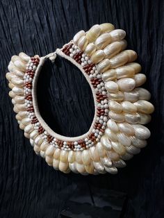 Slipper Shell Necklace from Asmat Tribal group in Papua, New Guinea! This is a vintage piece worn by tribal leaders for dance, rituals and ceremonies! Includes display stand. Can be worn or displayed in your collection on the stand. Stylish to wear at parties and events or great collector’s piece! Traditional Handwoven Necklaces For Festivals, Traditional Handwoven Necklace For Festivals, Artisan Necklace For Ceremonial Festivals, Artisan Necklaces For Traditional Ceremonies And Festivals, White Bohemian Necklace With Tilla Detail, White Bohemian Tilla Necklace, Artisan Choker For Festivals, Adjustable Bohemian Necklaces For Puja, Adjustable Bohemian Necklace For Puja