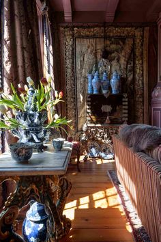 a living room filled with furniture and vases