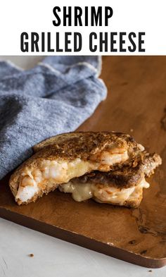 a grilled cheese sandwich on a cutting board with the words shrimp grilled cheese