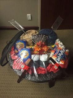 a basket filled with candy and snacks on top of a carpeted floor next to a door