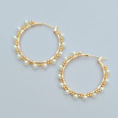 Indulge in the luxury our stunning pearl gold beaded hoops measuring at 30mm - a versatile and chic addition to any jewelry collection.  Handsewn with exquisite 24k gold plated glass beads and lustrous South Sea pearls, these earrings offer the perfect blend of elegance and modern style. The lightweight design makes them comfortable for all day wear, while the intricate craftsmanship ensures durability and lasting beauty.  Whether you're dressing up for a special occasion or adding a touch of gl Elegant Hoop Earrings With Gold Beads, Elegant Gold Pearl Earrings With Gold Beads, Elegant Gold Beaded Hoop Jewelry, Gold Pearl Earrings For Everyday Elegance, Elegant Beaded Hoop Earrings, Everyday Elegance Gold Pearl Earrings, Feminine Gold Hoop Earrings For Wedding, Elegant Small Hoop Earrings With Gold Beads, Gold Pearl Earrings With Gold Beads