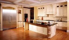 a kitchen with white cabinets and an island in front of the stove top oven is shown before and after remodeling