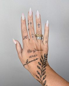 a woman's hand with tattoos on it