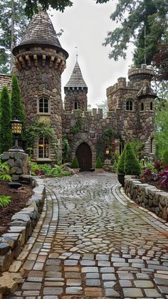 a stone walkway leading to a castle like building