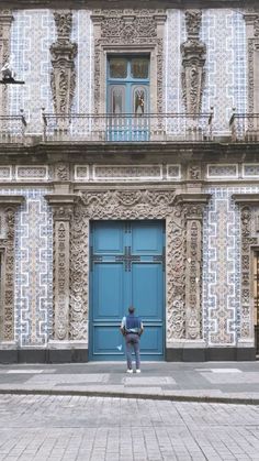 a person standing in front of a blue door