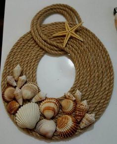 a rope wreath with seashells and starfish on it