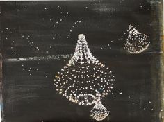 a blackboard with white and silver designs on it, in the shape of a chandelier