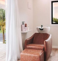 a bath room with a chair a sink and a mirror on the wall next to a window