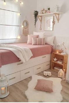 a bedroom with white walls and pink bedding