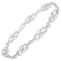 Treat yourself to this elegant and refined infinity link bracelet. Created in cool .925 sterling silver, this piece is designed with silver infinity links, alternating set with round-cut diamonds. This prong set, diamond accent piece is 7.25 inches in length and will be the perfect addition to your jewelry collection. Each genuine stone is round-cut and I3 clarity, which is at the lower end of the diamond color and clarity grading scale; the white diamonds are I-J color, and may appear more grey Silver Infinity Diamond Bracelet For Formal Occasions, Elegant Sterling Silver Link Bracelet, Elegant Sterling Silver Infinity Chain Bracelet, Formal Sterling Silver Infinity Bracelet, Formal Sterling Silver Infinity Bracelets, Classic Infinity Bracelet For Formal Occasions, Classic Sterling Silver Infinity Bracelet, Elegant Sterling Silver Bracelet With Solid Link Construction, White Gold Infinity Bracelet For Formal Occasions