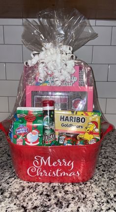 a red basket filled with lots of food on top of a counter