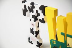 two wooden letters made to look like farm animals