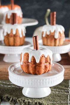 mini cinnamon bundt cakes with white icing and cinnamon sticks on top, ready to be eaten