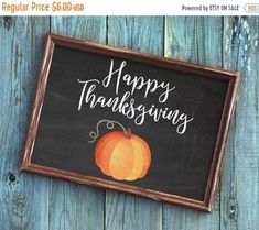 a chalkboard sign that says happy thanksgiving with a pumpkin painted on the front and bottom