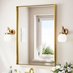 a bathroom sink with a mirror above it and a vase on the counter next to it