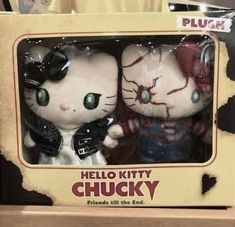 two hello kitty plush toys are in a box on the shelf next to each other