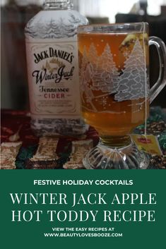 an advertisement for winter jack apple hot toddy recipe on a table with two bottles