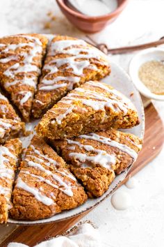 a plate topped with sliced up carrot scones covered in icing and drizzled