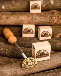 some woodworking tools are laying on top of logs and pieces of wood that have been carved into them