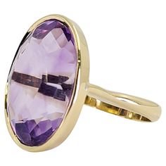 18 Karat Yellow Gold Cocktail Ring Featuring A 35 Carat Bezel Set Oval Amethyst. Finger Size 5; Purchase Includes One Sizing Service. Finished Weight Is 13.7 Grams. Luxury Polished Amethyst Oval Cabochon Ring, Oval Amethyst Ring, Amethyst Cocktail Ring, Bling Ideas, Yellow Gold Cocktail Ring, Middle Finger Ring, Gold Rings Jewelry, Gold Cocktail Ring, Gold Cocktail