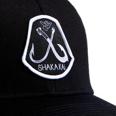 Whether you're hitting the beach or exploring the city, this hat is more than an accessory—it's a statement of your passion for the ocean. Embrace the Shakakai lifestyle and top off your look with the Hooked 6 Panel Trucker Hat, an emblem of your adventurous spirit and love for the endless horizons of the sea. Casual Black Trucker Hat With Wide Brim, Adjustable Fitted Cap For Beach, Black Wide Brim Trucker Hat In Casual Style, Casual Black Wide Brim Trucker Hat, Black Snapback Fitted Hat For Summer, Adjustable Fitted Hat With Curved Bill For Summer, Adjustable Curved Bill Hat For Beach, Adjustable Curved Bill Beach Hat, Adjustable Curved Bill Hat For The Beach