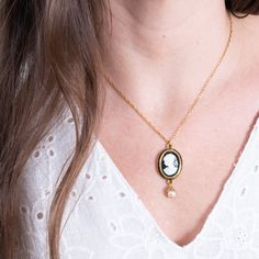 "A lovely luxurious black cameo pendant depicting a Victorian lady set in a 24K Antique Gold Plated oval frame with a small Preciosa glass pearl hanging down. The chain is dainty 24K Antique gold plated with a comfy lobster clasp closure. The back of the pendant has a beautiful engraving as well. Find matching earrings here: https://www.etsy.com/listing/71217516 The Details: 0.7\" long oval lady cameo (18mmx13mm) 24K Gold Plated Pendant 24K Gold Plated Chain Lobster Clasp The necklace is shipped Oval Pendant Necklaces With Cabochon For Wedding, Oval Pendant Cabochon Necklace For Wedding, Wedding Necklaces With Oval Cabochon Pendant, Oval Cabochon Pendant Necklace For Weddings, Victorian Gold Necklace With Oval Cabochon, Victorian Gold Oval Cabochon Necklace, Wedding Cabochon Medallion Necklace, Classic Cameo Necklace With Oval Pendant, Elegant Cameo Medallion Jewelry