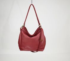 "THE SIZE SHOWN IN PICTURES IS THE LARGE HOBO BAG. This red soft leather bag from the HELEN collection is our most popular product as it is also a stylish women laptop bag. A feminine and modern large lightweight leather bag designed with plenty of storage space and organiser pockets is a must have purse for every women. Ideal for any occasion and any style you can wear this red hobo purse short on the shoulder or using the long strap you can go with a casual style and hands - free. That makes a Red Handheld Hobo Bag For Shopping, Red Hobo Tote Bag For Daily Use, Red Hobo Bag Tote For Daily Use, Red Handheld Hobo Bag For Travel, Red Rectangular Hobo Bag For Everyday Use, Burgundy Hobo Shoulder Bag For Travel, Red Flap Shoulder Bag For Everyday Use, Burgundy Handheld Shoulder Bag For Everyday Use, Everyday Red Soft Leather Hobo Bag