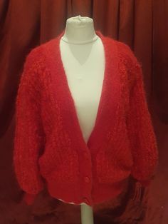 Here is a Great Vintage Mohair Red Cardigan, this is a beautiful Vintage Mohair Cardigan with 3 buttons at the front, this cardigan has a ribbons effect in lines really beautiful also this cardigan is fully lined.  Please take a minute to have a look at this beautiful vintage cardigan  A great vintage piece for All you great vintage lovers  Label : Knit One - Made in Taiwan - M.   Measurements :   Approximately  Shoulder to shoulder :   16 -  Inches  (measured along the back) Chest :  22 - Inches (measured 1 side double for all around ) ( measured under the armpits) Sleeve :   23 - 1/2 Inches ( including the cuff ) Length :   25 - 1/2 Inches ( including the hem ) ( measured under the back )  Condition : Vintage Condition Pulls on the mohair lose threads lonjas marks and stains, seams come Vintage Red Knit Cardigan, Red Vintage Knit Cardigan, Red Knitted Cardigan, Come Undone, Red Cardigan, Vintage Cardigan, Mohair Cardigan, Vintage Button, Vintage Lover