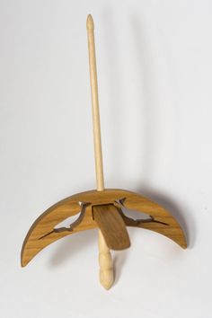 a wooden stand with a handle and two curved sections on the top, against a white background