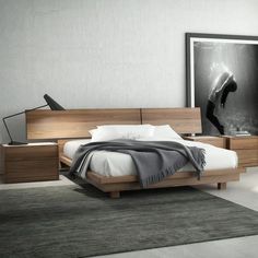 a modern bedroom with white walls and wood furniture