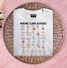 a white t - shirt that says nursing sling alphabet on the front and back with cartoon characters