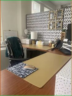 an office with a desk, chair and wallpaper on the walls in front of it