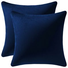 two dark blue pillows sitting next to each other