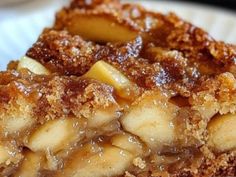 a close up of a piece of pie on a white plate with brown sugar topping