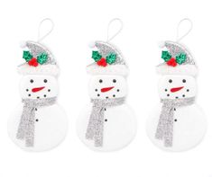 three snowmen with hats and bows on their heads