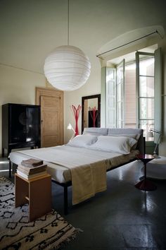 a bedroom with a large bed and white sheets