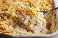 a casserole dish with mashed potatoes and parmesan cheese