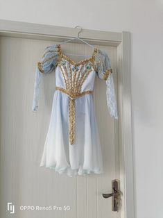 an open door with a dress hanging on it