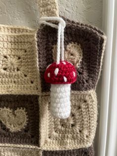 a crocheted bag with a mushroom hanging from it