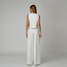 Introducing our Dove Silk Crepe Pants, a statement of luxurious comfort and timeless style. Tailored from white silk crepe with a wide-leg cut, they feature expertly placed darts that contour the waist and flatter the silhouette. The pressed crease detail offers a touch of refinement, elevating the overall look with understated polish. A concealed zipper and hook fastening in the front ensures a seamless finish, while the inclusion of pockets adds a practical yet chic element to the ensemble.  M Elegant Tailored White Wide Leg Pants, Tailored White Wide Leg Pants, Elegant White Silk Bottoms, White Wide Leg Pants For Evening, Elegant White Silk Pants, White Silk Wide-leg Pants, Elegant White Wide Leg Pants For Formal Occasions, Chic White Wide Leg Pants For Evening, White Full-length Evening Pants