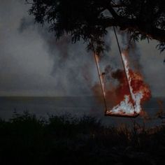 a swing that is on fire in the dark