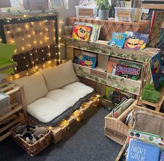 a room filled with lots of books and boxes full of stuff on the floor next to each other