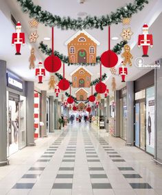 an indoor shopping mall decorated for christmas with gingerbread houses and decorations hanging from the ceiling