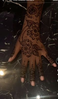 a person's hand with henna tattoos on it