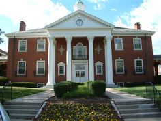 a large red brick building with white columns