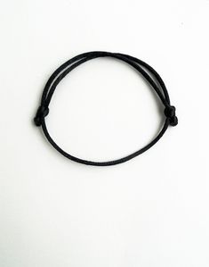 Black rattail satin cord mens bracelet - husband gift This handmade bracelet is made using 2mm thick rattail black satin cord. It is easily adjusted to fit any size of wrist comfortably. Similar rattail bracelet: https://www.etsy.com/listing/230001118/kabbalah-red-braceletsimple?ref=shop_home_active_5&ulsfg=true More string bracelets in my shop: https://www.etsy.com/shop/LuckyRatJewellery?section_id=16685466&ref=shopsection_leftnav_2 *Colours may differ slightly from the original due to Minimalist Braided Bracelet With Sliding Knot For Friendship, Minimalist Braided Friendship Bracelets With Sliding Knot, Simple Black Bracelets As Gift, Minimalist Braided Friendship Bracelet With Sliding Knot, Simple Black Bracelets For Gift, Simple Black Bracelets For Gifts, Simple Black Bracelet For Gift, Minimalist Adjustable Braided Bracelet With Sliding Knot, Minimalist Adjustable Braided Bracelet